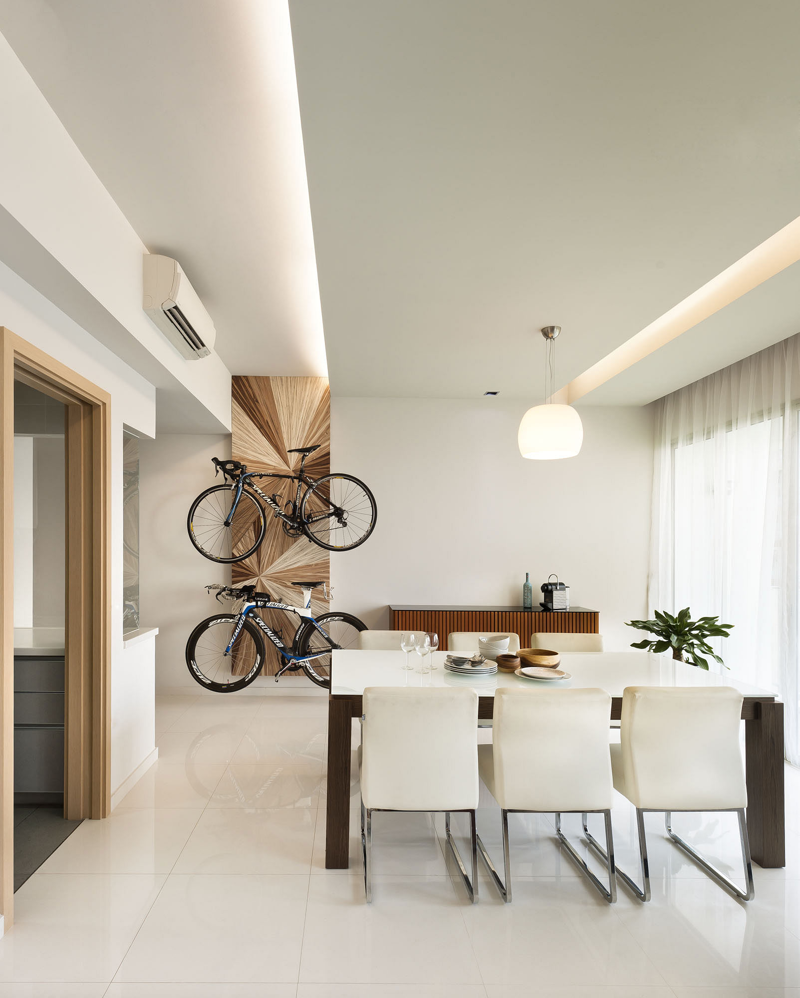 Hung neatly, the two sporty bicycles don't mar the elegant decor in this dining room of a condominium in the Livia Condo, Pasir Ris Grove.