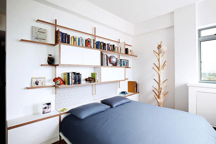 Shelves similar to those in the living room comprise the headboard of the customised bed in the master bedroom.