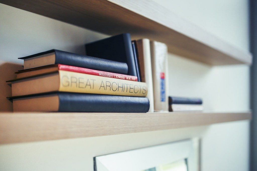 Mix things up for your bookshelf design. Put some books standing straight up and others stacked lying down to keep it interesting. Photo: Pixabay