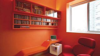 Bright orange study room in this 3-bderoom condominium designed by interior designer Raymond Seow from Free Space Intent.