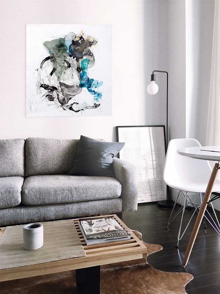 Artwork 'BE86Sen' by artist Yan Sen hanging on a wall above a sofa in a living room. Photo from The Artling.