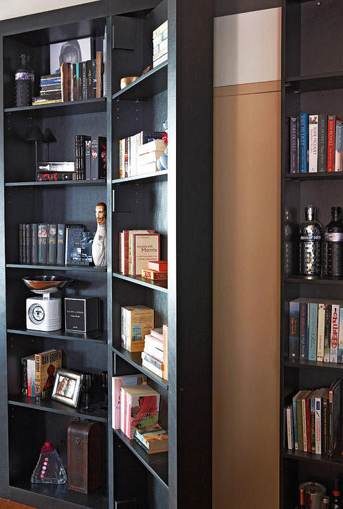 This bookshelf was built over the door of the bomb shelter to conceal it. Design by Sirius Art