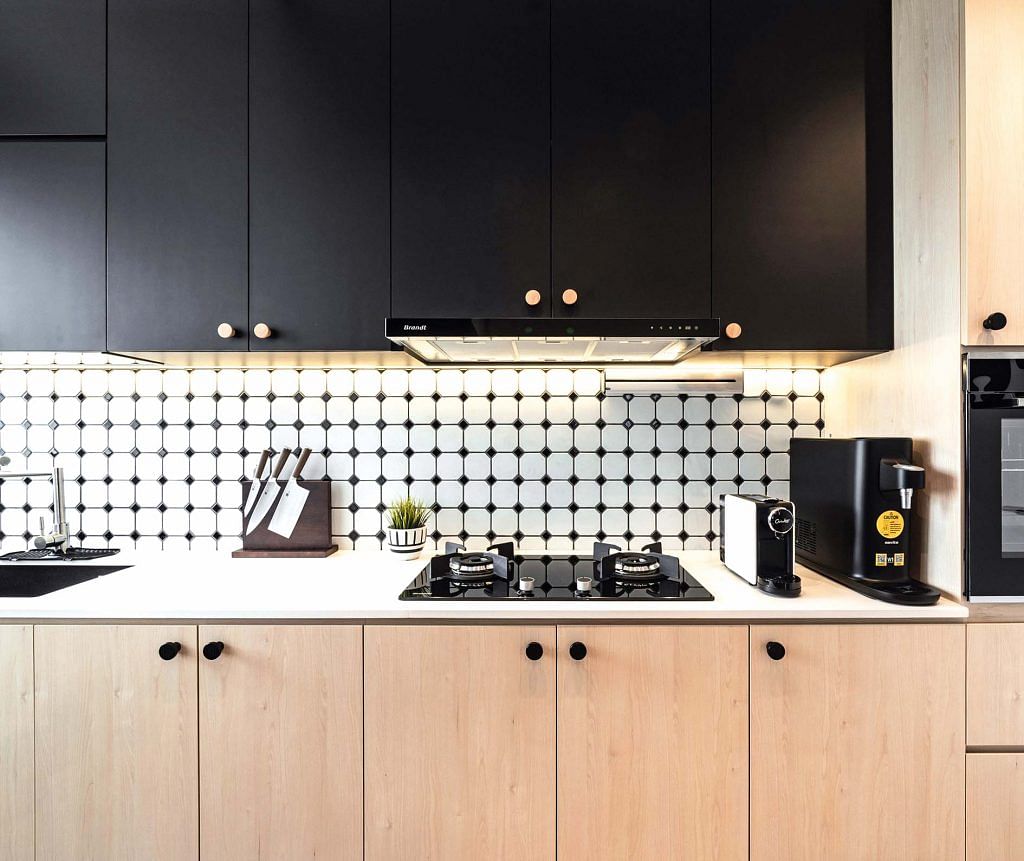 The kitchen, with black and light wood cabinets.