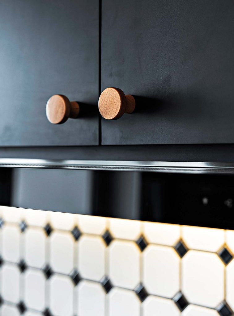Wood handles on black cabinets